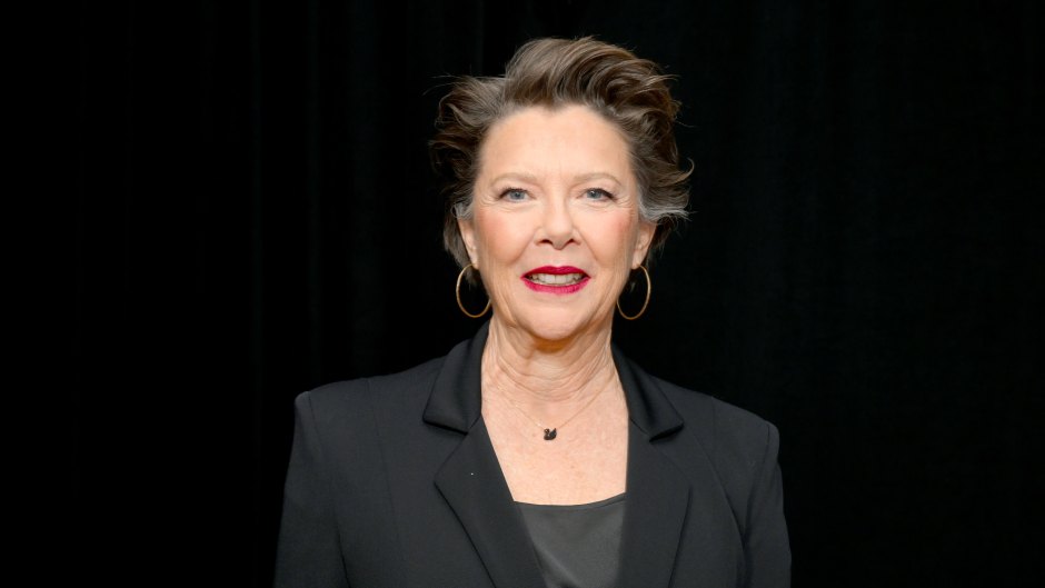 Annette Bening wears black blazer and black top with red lipstick