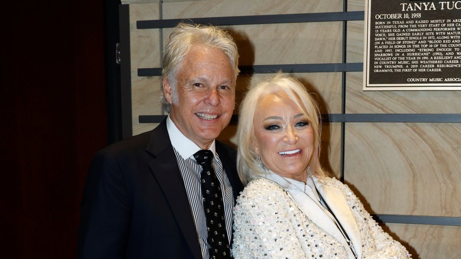 Tanya Tucker poses with her arms crossed in front of boyfriend Craig Dillingham