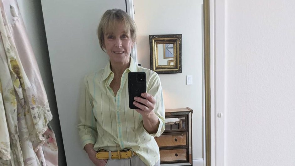 Karen E. Laine wears green shirt with jeans in mirror selfie