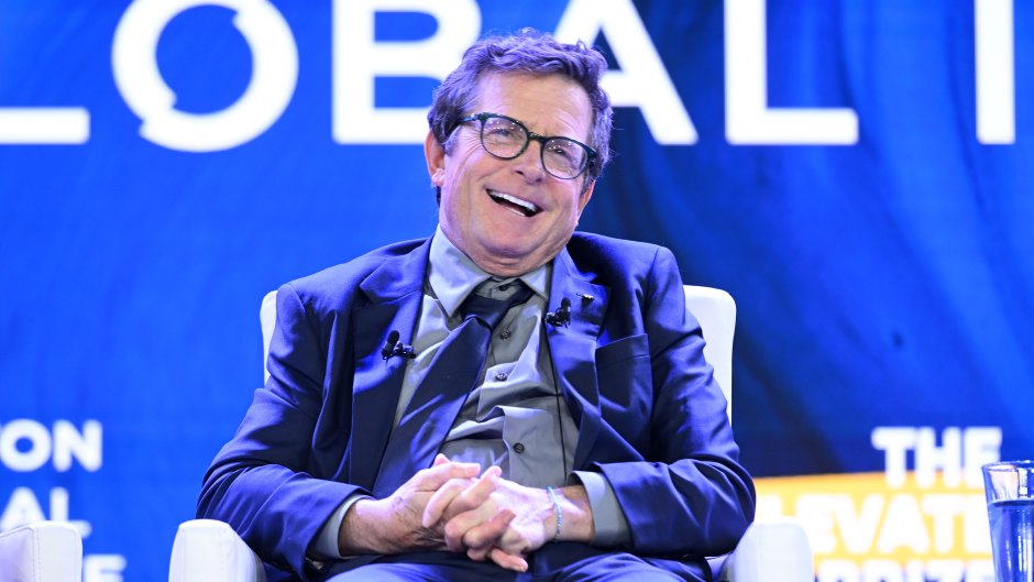 Michael J. Fox laughs while sitting in chair