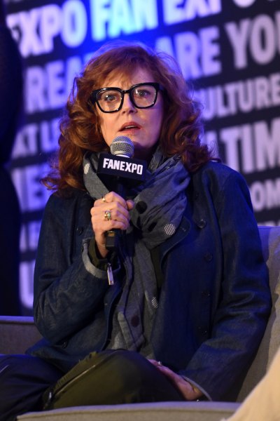 Susan Sarandon sits on chair with microphone in her hand 