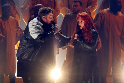 Wynonna Judd holds onto Jelly Roll's arm on stag at CMA Awards