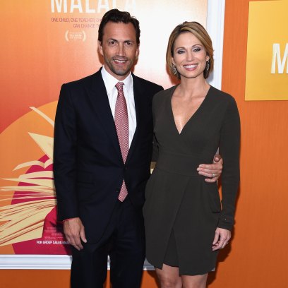 Amy Robach wears short green dress next to Andrew Shue