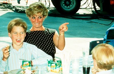 Princess Diana and Prince William sitting together at table 