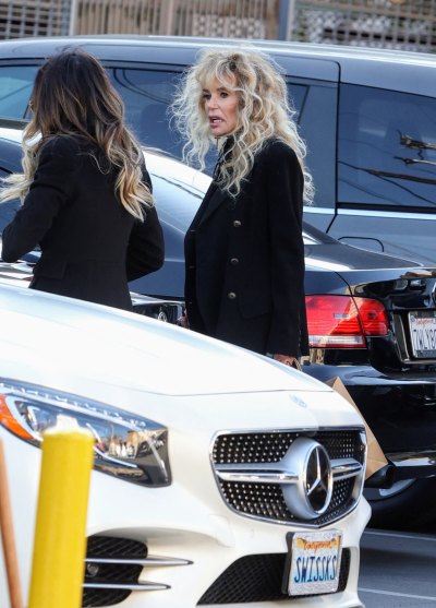 Dyan Cannon standing in front of car in black jacket