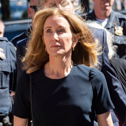 Felicity Huffman in a black dress walking into court
