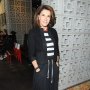 Hilary Farr in a black coat with black pants and black shoes