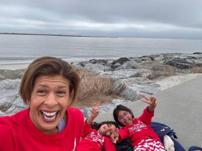 Hoda Kotb sits on the beach with her kids in matching pajamas