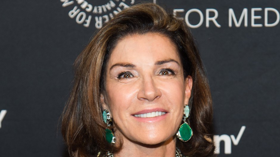 Hilary Farr wears a black shirt with green earrings and a green necklace