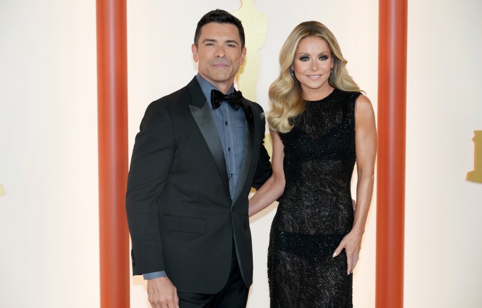 Kelly Ripa wears a black formal gown next to husband Mark Consuelos wearing a tuxedo