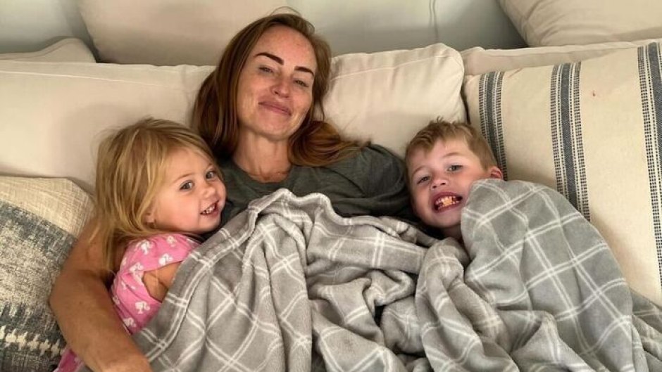 Mina Starsiak Hawk lays under blanket with kids Jack and Charlotte