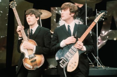 Paul McCartney and John Lennon perform together with guitars