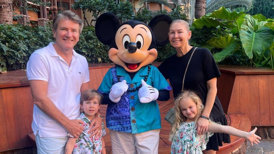 Robert Herjavec and wife Kym Johnson pose with Mickey Mouse and their kids