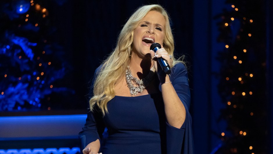 Trisha Yearwood sings on stage in a navy blue formal gown