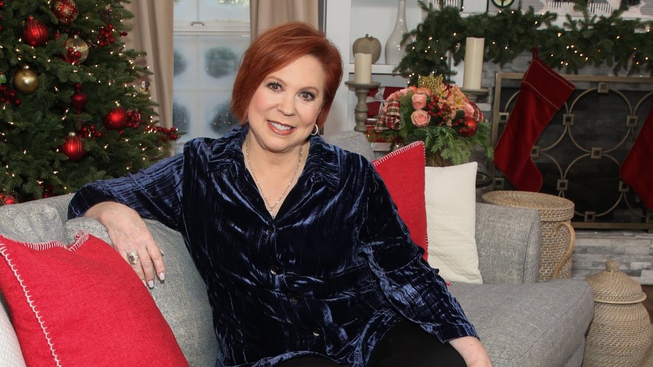 Vicki Lawrence sits on couch in blue velvet shirt