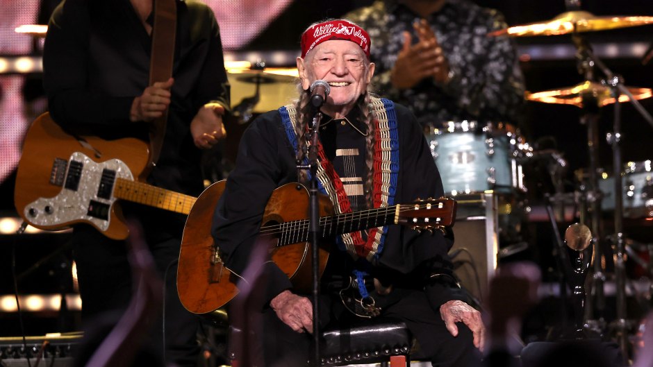 Willie Nelson on stage with a guitar at the 38th Annual Rock & Roll Hall Of Fame Induction Ceremony