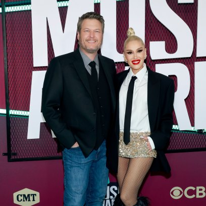 Blake Shelton in a suit jacket and jeans with wife Gwen Stefani