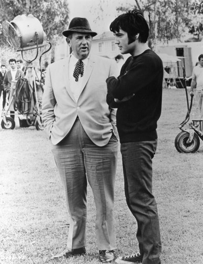 Elvis Presley confers with Colonel Tom Parker on the set of movie