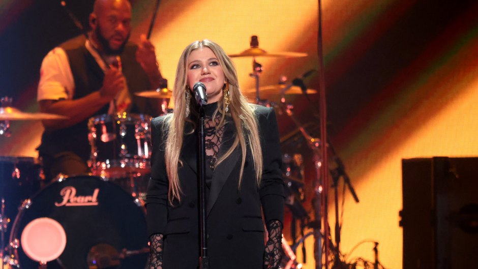 Kelly Clarkson performs on stage in a black blazer