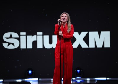 Kelly Clarkson performs in a red jumpsuit