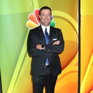 Carson Daly wears black suit with blue tie