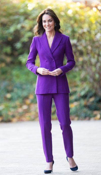 Kate Middleton smiles in a purple pantsuit