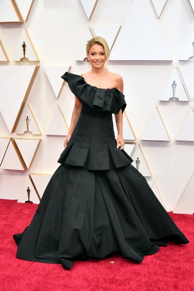 Kelly Ripa smiles in a black one-shoulder gown