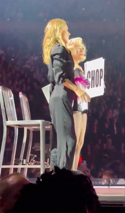 Kelly Ripa standing on stage with Madonna