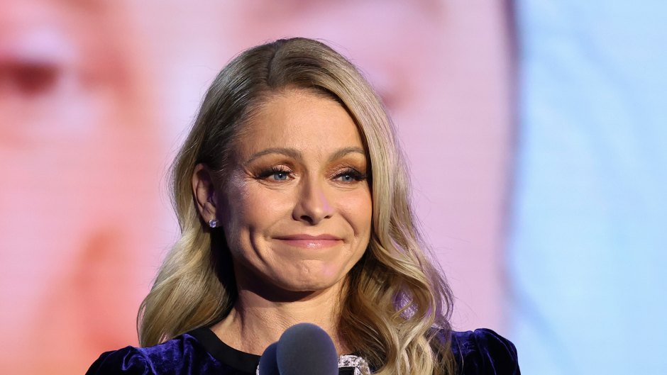 Kelly Ripa stands at microphone at event