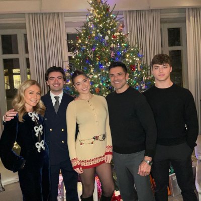 Kelly Ripa and Mark Consuelos pose with their kids in front of Christmas tree