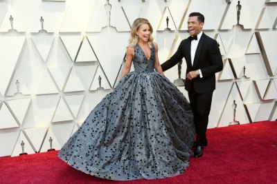 Kelly Ripa wears gray dress with Mark Consuelos standing close by