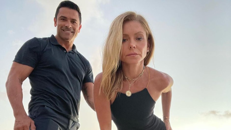 Kelly Ripa and Mark Consuelos pose together while standing on a rock