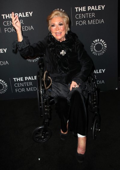 Mitzi Gaynor waves in wheelchair