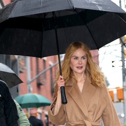 Nicole Kidman holds black umbrella in the rain