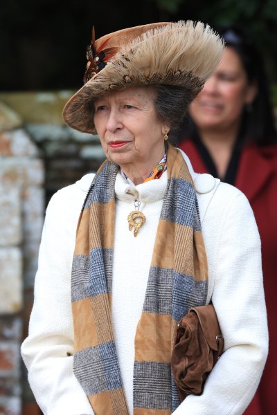 Princess Anne in a brown hat and white sweater