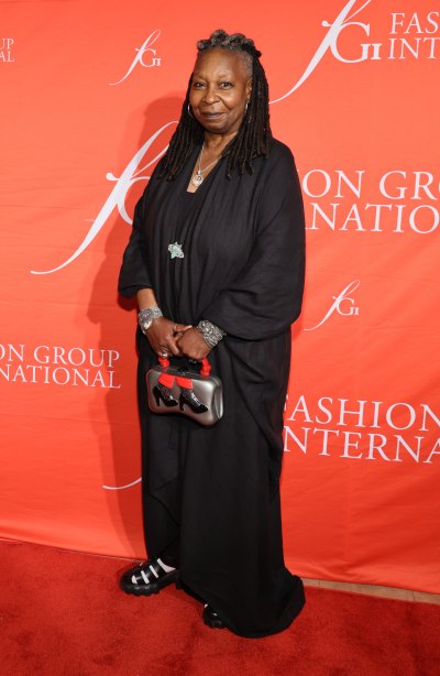 Whoopi Goldberg in a black dress with black sandals