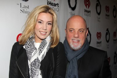 Billy Joel and Alexis Roderick pose for a photo at a Broadway show.