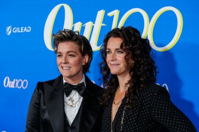 Brandi Carlile and Catherine Shepherd pose for a photo at the Out100 Party in 2023.