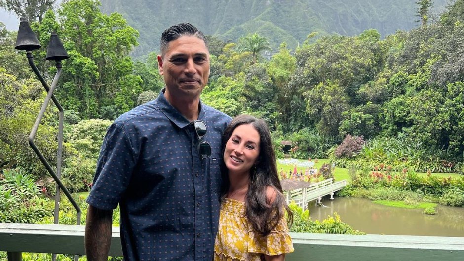 Renovation Aloha's Tristyn and Kamohai Kalama pose for a photo in front of scenic Hawiian mountainside