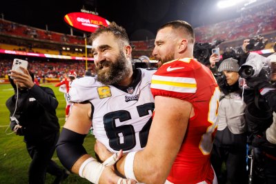Travis Kelce and Jason Kelce hug on the field after the Chiefs took on the Eagles in November 2023.