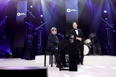 Elton John on stage after knee surgery 